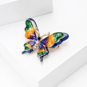 Detailed view of the enamel butterfly brooch with colorful gradients and crystals