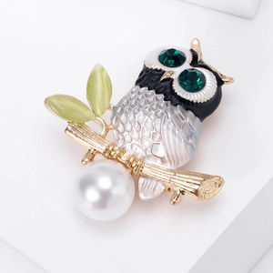 Enamel owl brooch with green crystal eyes and white pearl pendant on branch
