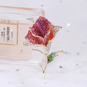 Macro shot of rose flower brooch with gradient crystals and gold-plated base detail