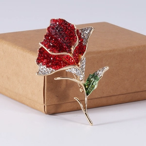 Macro detail of elegant rose brooch featuring sparkling red, white, and green rhinestones