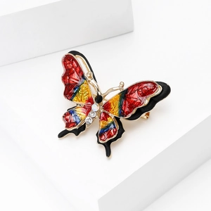 Detail view of colorful enamel butterfly brooch with gold plating and sparkling crystals