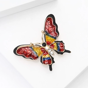 Detailed close-up of colorful enamel butterfly brooch with inlaid sparkling rhinestones