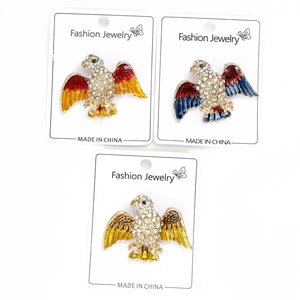 Detailed view of rhinestone eagle brooches with colorful enamel wings on display cards