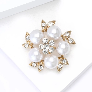 Elegant gold flower brooch with white faux pearls and sparkling crystal rhinestones