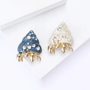 Creative alloy enamel hermit crab brooches with rhinestones on white display blocks