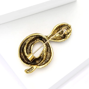 Detailed back view of golden snake-shaped alloy brooch with secure pin closure mechanism