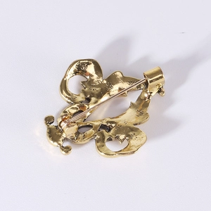 Vintage gold iris flower brooch shown from back view with safety pin and textured finish