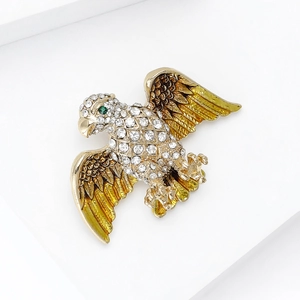 Macro view of eagle brooch featuring gradient enamel wings and sparkling crystal rhinestones