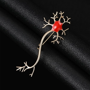Macro detail of neuron cell brooch with gold plating and vibrant red enamel finish