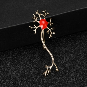 Detailed macro shot of neuron brooch with gold plating and red enamel finish on black leather