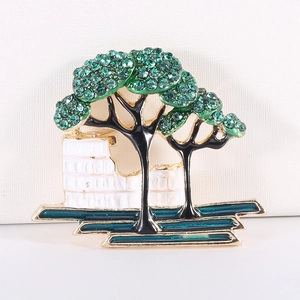 Creative tree brooch with green crystals and black enamel in a stylish alloy finish
