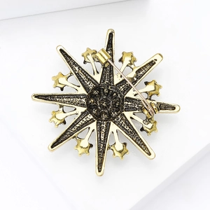 Vintage gold snowflake brooch in alloy with an antique finish shown from the back side