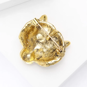 Back view of vintage golden tiger head brooch in matte alloy finish with safety pin