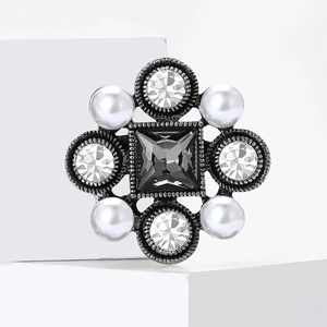 Detail shot of vintage Baroque brooch with black crystal and white pearl embellishments