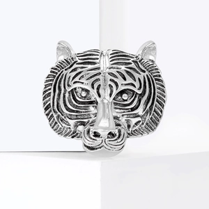 Retro silver tiger head brooch with vintage 3D relief details on white background