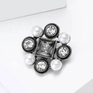Macro shot of vintage baroque brooch with grey gemstone and elegant pearls inlay
