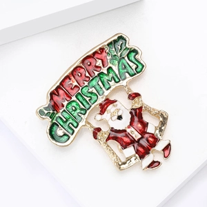 Broche Père Noël Joyeux Noël en émail avec finition métal doré et goutte d'huile rouge
