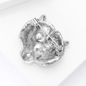 Detailed back view of the tiger head brooch showing metal texture and safety pin clasp