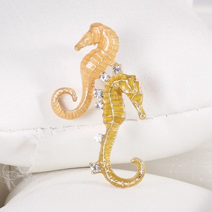 Detailed view of intertwined seahorse brooch with colorful enamel and sparkling rhinestones