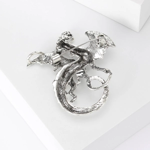 Detail view of the vintage silver dragon brooch back with a secure metal pin clasp