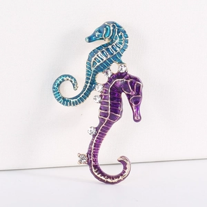 Detail of vibrant seahorse brooch with colorful enamel finish and sparkling crystal accents