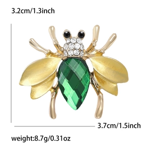 Exquisite gold-tone bee brooch with large green teardrop gemstone and white rhinestones