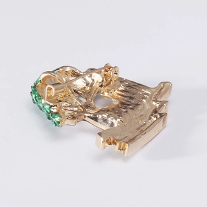 Back view of gold-plated tree brooch with secure pin clasp and green rhinestone accents