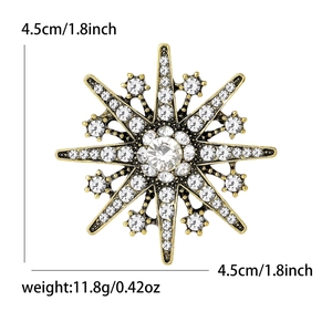 Vintage snowflake brooch in gold-tone metal with sparkling white rhinestones and zircon