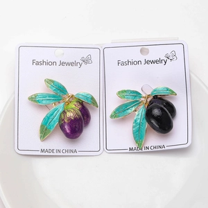 Detail view of alloy olive branch brooches with purple and black rhinestones