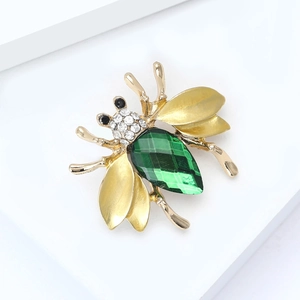 Elegant gold bee brooch with green faceted gemstone and sparkling rhinestone wings