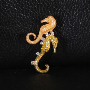 Close-up of enamel seahorse brooch with colorful dripping oil and sparkling rhinestones
