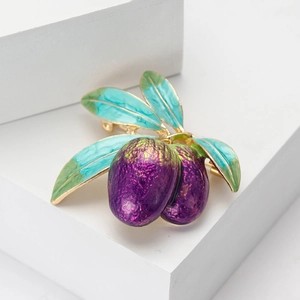 Elegant enamel olive branch brooch with purple fruit and green leaves on white background