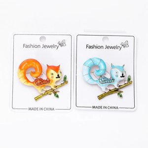 Detailed close-up of colorful enamel squirrel brooches with sparkling crystal rhinestones
