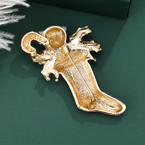 Christmas stocking brooch with candy cane design featuring a secure gold metal safety pin
