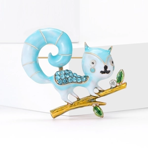 Cute squirrel brooch with blue rhinestones and enamel on a gold branch base