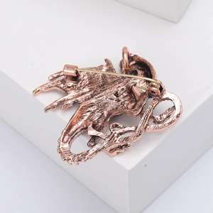 Detailed back view of vintage fire dragon brooch with secure pin clasp and metal texture