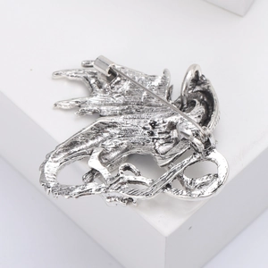 Detailed back view of vintage dragon brooch showing the pin mechanism and metal texture