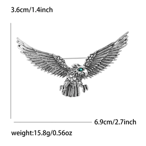Detailed size view of retro eagle brooch featuring green gemstone eyes and silver finish