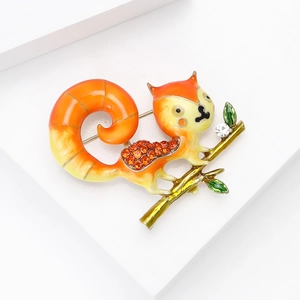 Detail view of squirrel brooch with enamel finish and sparkling orange rhinestones