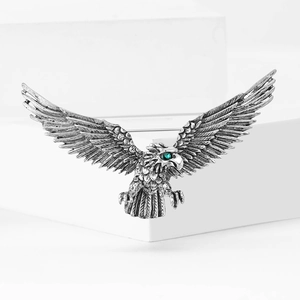 Retro eagle brooch in vintage silver finish with green crystal eye and detailed wings