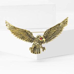 Vintage eagle brooch in antique gold finish with red rhinestone eye and feather texture