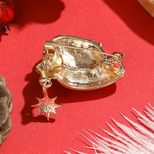 Detailed back view of Christmas hat brooch with gold star pendant and metal pin clasp