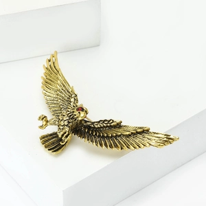Detailed close-up of eagle brooch featuring vintage gold finish and fine feather textures