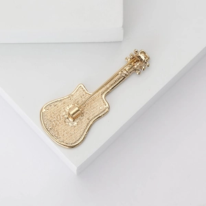 Detailed back view of guitar shaped alloy brooch showing the secure pin fastener and texture