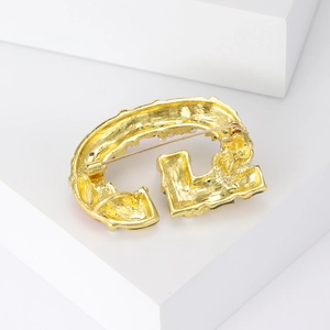 Classic gold alloy letter G brooch with pearl accents and textured metal finish