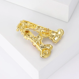 Golden retro pearl letter A brooch showing detailed metallic back with secure pin clasp
