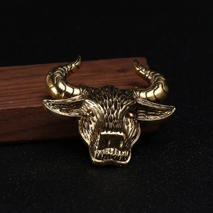 Macro detail of vintage gold bull head brooch with realistic engraved alloy textures