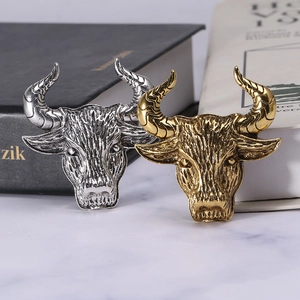 Vintage bull head brooch in antique gold and silver finishes with embossed details