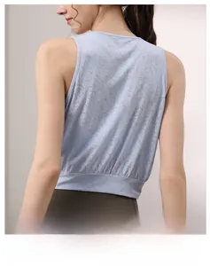 Macro shot of breathable jacquard fabric and ribbed hem on light blue yoga tank top