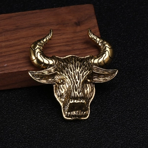 Macro detail of retro gold bull head brooch showing vintage texture and fine carving
